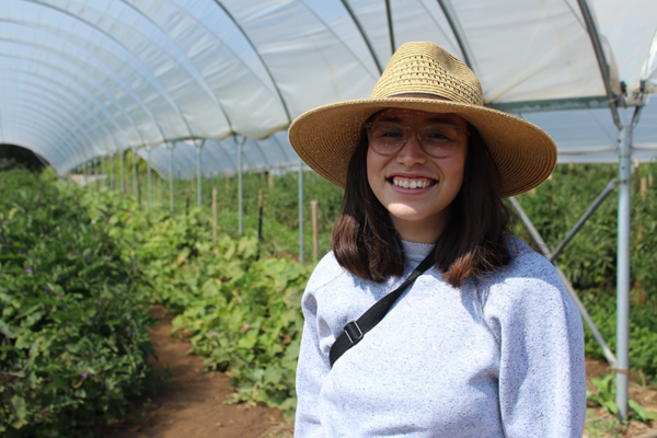 student in a greenhouse